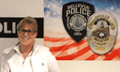 A woman in a white shirt stands beside a wall adorned with Bellevue Police badges, an American flag proudly waving in the backdrop, reminiscent of the prestigious Foundation Awards. Bellevue Police Foundation