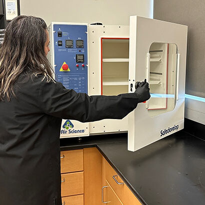 A woman opening the Safe DEVELOP™ Fingerprint Development Chamber