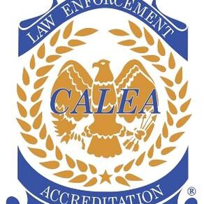 The emblem of the Commission on Accreditation for Law Enforcement Agencies (CALEA) features an eagle and laurel wreath design, symbolizing excellence and re-accreditation.