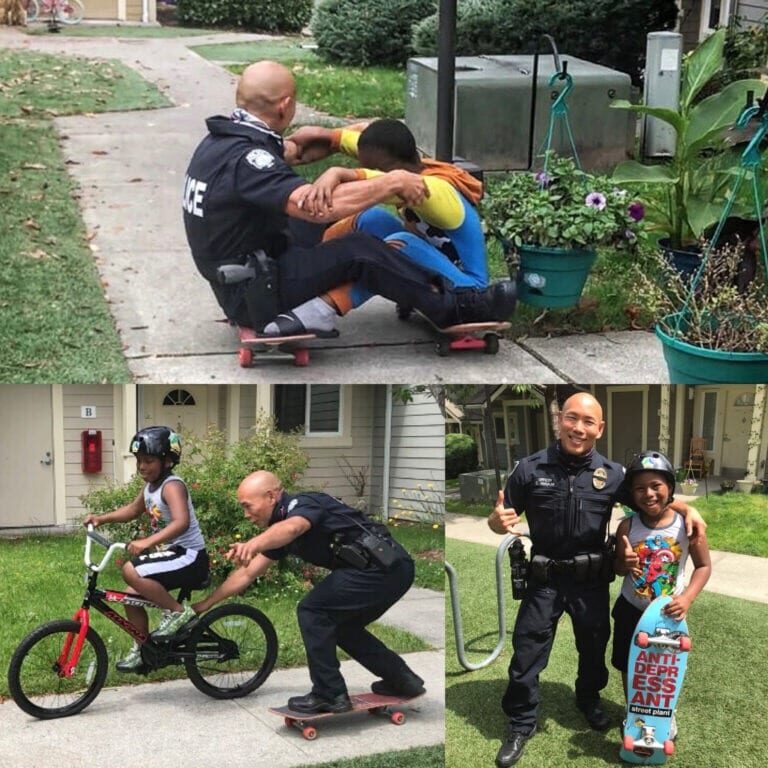 A Bellevue police officer in uniform promotes public safety by interacting with children: sitting with one on a skateboard, assisting another on a bike, and posing with a third proudly holding a skateboard.